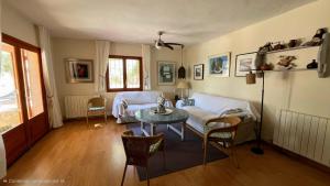 a living room with a couch and a table at Casa la Paloma in Es Caló