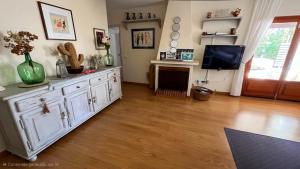 a living room with a white cabinet and a tv at Casa la Paloma in Es Caló