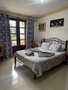 a bedroom with a bed and a window at La casita de Adri habitación privada en alojamiento compartido en zona colonial in Santo Domingo