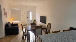 a living room with a dining room table and a television at Moderno apartamento en Colón in Colón Buenos Aires Province
