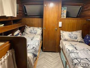 a small room with two beds on a boat at Original Friendly Boat in Sant Pau dʼOrdal +131 photos