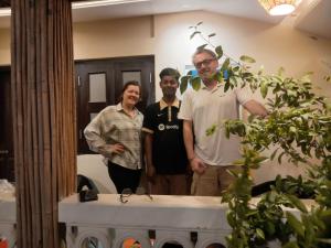 a group of people standing in front of a mirror at Jolpoddo Retreat in Sreemangal
