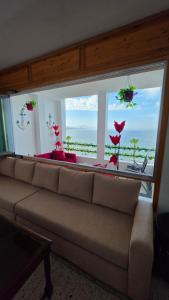 a living room with a couch in front of a window at Star beach in M'diq