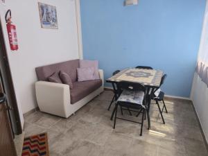 a living room with a couch and a table at Sa domu nosta è un appartamento. in Castiadas