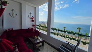 a living room with a couch and a view of the ocean at Star beach in M'diq