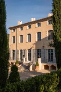 a large building with a staircase in front of it at Château du Grand Pré in Vitrolles-en-Luberon