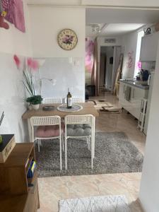 a living room with a table and two chairs at KiDo Apartman in Balatonberény