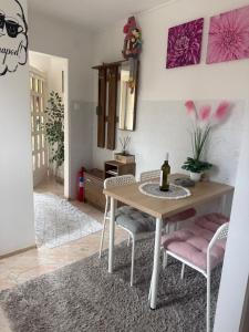 a dining room with a table and two chairs at KiDo Apartman in Balatonberény