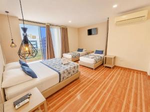 a hotel room with two beds and a window at Vadamar Hotel Collection Rodadero in Gaira +42 photos