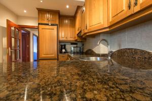 a kitchen with wooden cabinets and a granite counter top at Calle Magallanes in Barakaldo