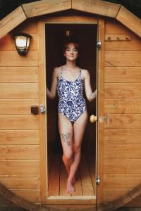 a woman in a bathing suit standing in a doorway at Chata Ignasia in Stronie Śląskie