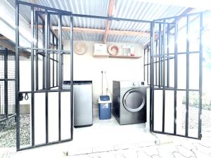 a laundry room with a washer and dryer in a building at The Angelique Oasis in Arusha