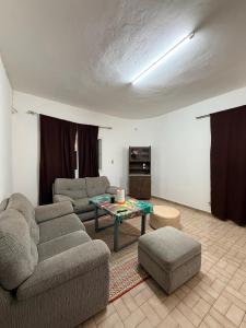 a living room with two couches and a table at L'Urbain in Ziguinchor