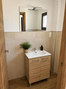 a bathroom with a sink and a mirror at Ca el retriñon in Felechosa +13 photos