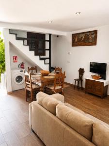 a living room with a couch and a table at Ca el retriñon in Felechosa
