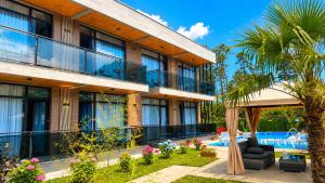 a resort with a swimming pool and a building at Apollo Cottages Kaprovani in Urekis Sadguri