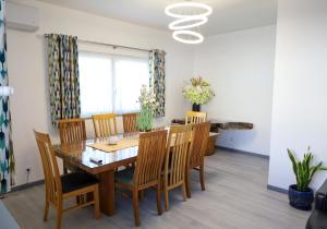 a dining room with a wooden table and chairs at North Pearl Guesthouse in Porto Moniz