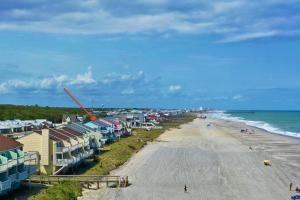an aerial view of a beach with houses and the ocean at Dune Our Thing in Kure Beach