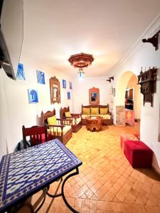 a large living room with couches and chairs at Dar Sababa in Chefchaouen