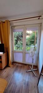 an empty room with a large window and a fan at Przy rynku in Olecko