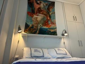 a tapestry hanging above a bed in a bedroom at Royal Zea Suite 3 in Piraeus