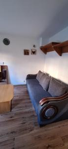 a bedroom with a bed and a wooden floor at Przy rynku in Olecko
