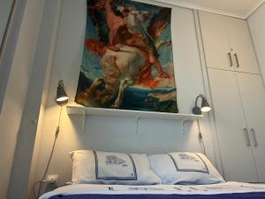 a tapestry hanging above a bed in a bedroom at Royal Zea Suite 3 in Piraeus