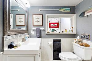a bathroom with a toilet and a sink and a mirror at Cozy Cottage w/ Hot Tub in Freeland, Pets Welcome! in Freeland +17 photos