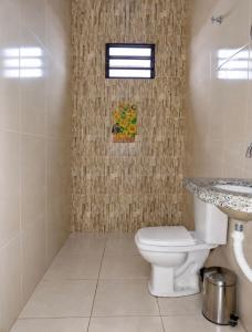 a bathroom with a toilet and a sink at Recanto sonho meu in Trindade +1 photo