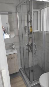 a shower with a glass door in a bathroom at Royal Zea Suite 3 in Piraeus