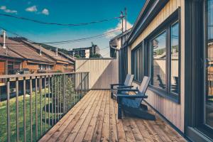 a wooden deck with two benches on a house at Unit 31 - 5 bedrooms, 8 people in Beaupré