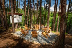 a group of chairs and tables in the woods at Вила Бучала Villa Buchala in Dyakovo