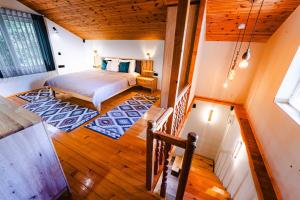 a bedroom with a king sized bed and a staircase at Вила Бучала Villa Buchala in Dyakovo