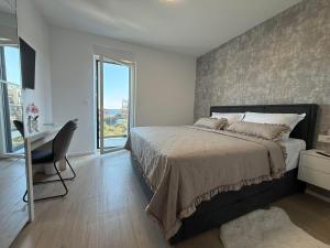 a bedroom with a bed and a desk and a window at Villa Omorfia - SEVID in Sevid +33 photos