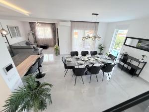 a living room with a dining table and chairs at Villa Omorfia - SEVID in Sevid