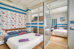 a bedroom with a large bed and a shower at Jūras Vilks in Ventspils
