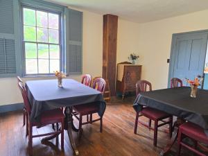 a dining room with two tables and chairs at The Cortina Inn in Donegal