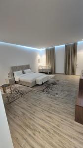 a large white room with a bed and a couch at Noor-Hatta Deluxe Villa Farmhouse in Hatta +72 photos