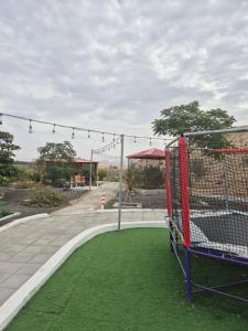 a batting cage in a park with green grass at Noor-Hatta Deluxe Villa Farmhouse in Hatta