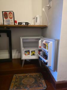 a small refrigerator with its door open in a room at Descanso de la Furia in San Carlos +6 photos