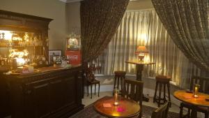 a bar with tables and chairs in a room at Northdene Theatre Hotel in Blackpool