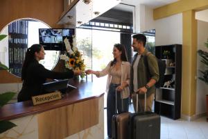 a man and a woman standing at a cash register at Villa Fernanda Hotel in Tacna