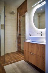a bathroom with a sink and a shower with a mirror at Nad Drwęcą in Mszano +35 photos