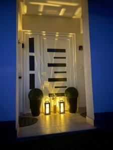a hallway with two lights and a door at Studio Apartman Jovičić in Bjelovar