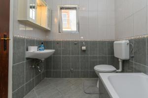 a bathroom with a toilet and a sink at Apartments Ian in Lopar +41 photos