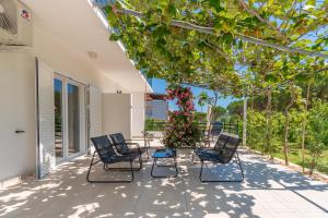 a group of chairs sitting on a patio at Apartments Ian in Lopar