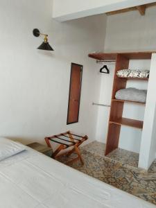 a bedroom with a bed and bunk beds and a chair at Roof Garden 3 in Coatepec