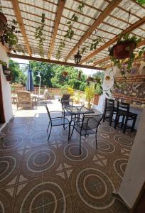 a patio with a table and chairs under a roof at Roof Garden 3 in Coatepec