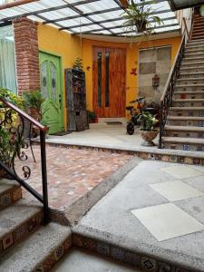 a house with a staircase leading to a front door at Roof Garden 3 in Coatepec