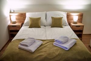 a large bed with two pillows on top of it at Nad Drwęcą in Mszano